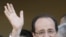 Socialist Party candidate for the presidential election Francois Hollande meets a resident with his companion Valerie Trierweiler, center, as he tours Tulle, after voting , May 6, 2012. 