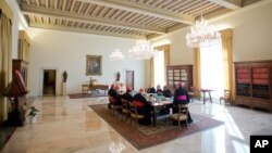 In this picture provided Oct. 1, 2013 by the Vatican newspaper L'Osservatore Romano, Pope Francis sits with his so-called "Group of Eight" cardinals, during their first meeting at the Vatican. 