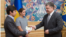 President Petro Poroshenko (R) hands a Ukrainian passport to Vladimir Fedorin as Maria Gaidar looks on, at a ceremony in Kyiv, Ukraine, August 4, 2015. (Photo source - president.gov.ua)