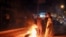FILE - Libyan youth block a road with burning tires as they protest the poor public services and living conditions, in Libya's eastern coastal city of Benghazi, Sept. 12, 2020.