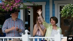 Democratic presidential candidate Sen. Amy Klobuchar, D-Minn., addresses fair goers from her fair booth during a campaign visit to the Minnesota State Fair in Falcon Heights, Minnesota, Aug. 22, 2019.