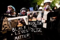 FILE - Black Lives Matter protesters march through Portland, Ore., August 2, 2020.