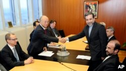 Iran's deputy Foreign Minister Abbas Araghchi, right, and Director General of the International Atomic Energy Agency, IAEA, Yukiya Amano shake hands prior to meeting in Vienna, Austria, Oct. 28, 2013.