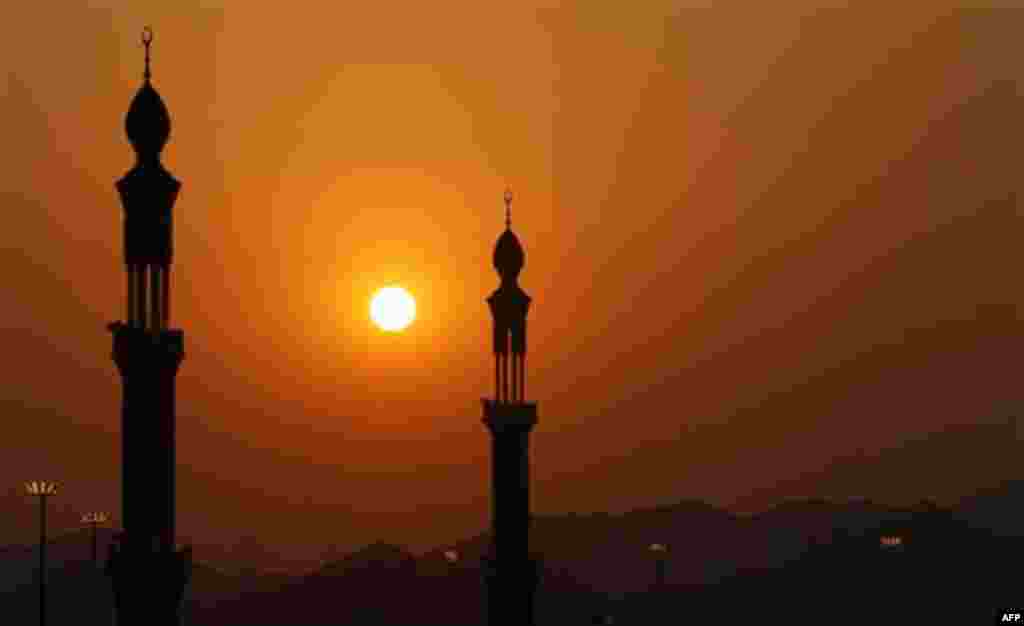 The minarets of Namira mosque are seen during prayers at sunset in Arafat near Mecca,, Saudi Arabia, Monday, Nov. 15, 2010. The annual Islamic pilgrimage draws 2.5 million visitors each year, making it the largest yearly gathering of people in the world.(