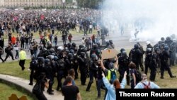 Protesters face off with police during a demonstration by French health workers in Paris, June 16, 2020.