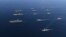 In this Nov. 12, 2017 photo provided by South Korea Defense Ministry, three U.S. aircraft carriers USS Nimitz, left top, USS Ronald Reagan, left center, and USS Theodore Roosevelt, left bottom, participate with other U.S. and South Korean navy ships during joint naval exercises between the United States and South Korea in waters off South Korea's eastern coast. 