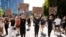 People march towards Trafalgar Square in central London on May 31, 2020 to protest against the recent killing of George Floyd by police officers in Minneapolis that has led to protests across the US. 