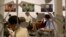 Portrait of farmers whose lands were confiscated hang on display while journalists attend a press briefing on a release of a project entitled "Nothing for Our Land," July 17, 2018, in Yangon, Myanmar.