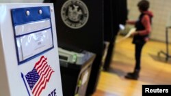 FILE - A woman casts her vote during the U.S. midterm elections in Staten Island, New York, Nov. 4, 2014.