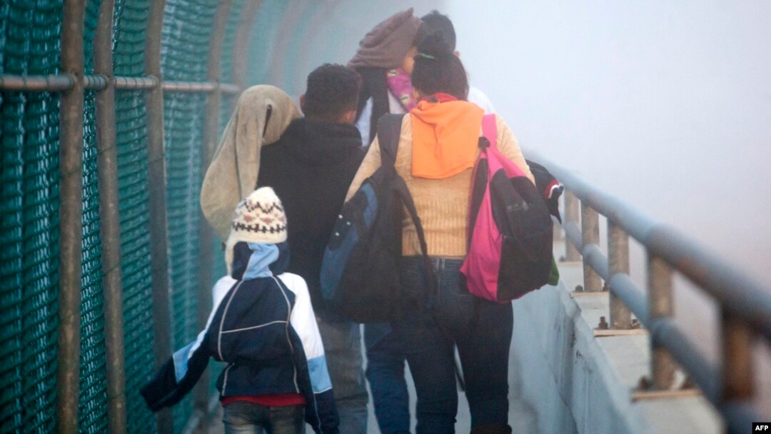 A Honduran family walks back to Piedras Negras, Coahuila state, Mexico at the international bridge, after being rejected by U.S. authorities in their attempt to enter Eagle Pass, Texas, Feb. 6, 2019. 