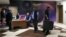 Watched by security personnel, a man carrying a suitcase leaves the shuttered offices of Saudi-owned TV news channel Al Arabiya in Beirut, Lebanaon, April 1, 2016.