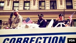 New York City Department of Corrections officers who are also proud military veterans had their own patriotic float in Monday's Veterans Day Parade up Fifth Avenue. (VOA/A. Phillips) 