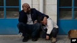 Mourners wait outside a morgue for the funeral of six Palestinians killed during an Israeli airstrike on Wednesday in the West Bank refugee camp of Jenin, Jan. 16, 2025.