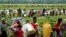 FILE - Rohingya refugees, who crossed the border from Myanmar two days before, walk after they received permission from the Bangladeshi army to continue on to the refugee camps, in Palang Khali, near Cox's Bazar, Bangladesh, Oct. 19, 2017.