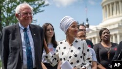 Democratic presidential candidate Sen. Bernie Sanders, I-Vt.., left, and Rep. Ilhan Omar, D-Minn., the sponsors of legislation to cancel all student loan debt, hold a news conference at the Capitol in Washington, June 24, 2019. 
