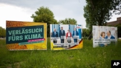 FILE - Election campaign posters from Germany's Green party and Christian Democratic Union party stand near a road in the federal state Saxony-Anhalt's capital Magdeburg, Germany, June 2, 2021.