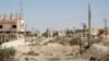 A general view shows a heavily damaged road in the recently retaken desert town of Al-Qaryatayn on Oct. 22, 2017.