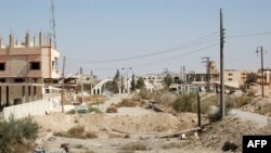 A general view shows a heavily damaged road in the recently retaken desert town of Al-Qaryatayn on Oct. 22, 2017.