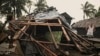 A resident checks his damaged home that was blown off by strong winds caused by Typhoon Man-yi in the municipality of Baler, Aurora province, northeastern Philippines, Nov. 18, 2024. 