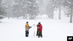California Cooperative Snow Surveys Program for the Department of Water Resources employees conduct a manual snow survey of the season at Phillips Station near Echo Summit, Calif., Feb. 2, 2016. 