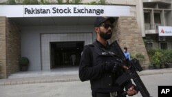 A police commando stands guard outside the Pakistan Stock Exchange after an attack in Karachi, June 29, 2020.