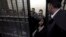 People accused of working for unlicensed non-governmental organizations awaiting trial hearings in a cage, Cairo, March 8, 2012.