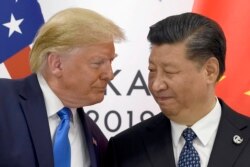 FILE - President Donald Trump meets with Chinese President Xi Jinping on the sidelines of the G-20 summit in Osaka, Japan, June 29, 2019.