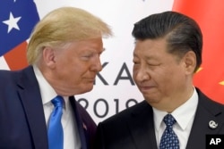 FILE - President Donald Trump meets with Chinese President Xi Jinping on the sidelines of the G20 summit in Osaka, Japan, June 29, 2019.