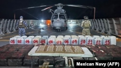 A photo released Oct. 19, 2024, by the Mexican Navy shows troops posing with packages of narcotics seized after intercepting six small boats southwest of the port of Lazaro Cardenas, off the state of Michoacan, Mexico. (Photo from Mexican Navy/AFP)