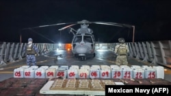 FILE - A photo released Oct. 19, 2024, by the Mexican Navy shows troops posing with packages of narcotics seized after intercepting six small boats southwest of the port of Lazaro Cardenas, off the state of Michoacan, Mexico. (Photo from Mexican Navy/AFP)