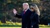 President Donald Trump and first lady Melania Trump walk to board Marine One on the South Lawn of the White House, Dec. 23, 2020, in Washington.