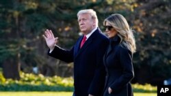 President Donald Trump and first lady Melania Trump walk to board Marine One on the South Lawn of the White House, Dec. 23, 2020, in Washington.