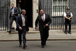 British Foreign Secretary Dominic Raab, left, walks with U.S. Secretary of State Mike Pompeo outside of 10 Downing Street, in London, July 21, 2020.