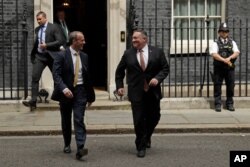 British Foreign Secretary Dominic Raab, left, walks with U.S. Secretary of State Mike Pompeo outside of 10 Downing Street, in London, July 21, 2020.