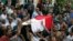 FILE - People carry the coffin, covered with the an Egyptian flag, of police Captain Ahmed Fayez at Al-Hosary mosque in Cairo, Oct. 21, 2017. Fayez was killed Oct. 20 in a gunbattle with militants in al-Wahat al-Bahriya area in Giza province, about 135 kilometers (84 miles) southwest of Cairo.