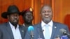 FILE: South Sudan's First Vice President and Chairman of the SPLM-In-Opposition party, Riek Machar, flanked by President Salva Kiir Mayardit, addresses a news conference at the State House in Juba, South Sudan February 20, 2020. REUTERS/Jok Solomun.
