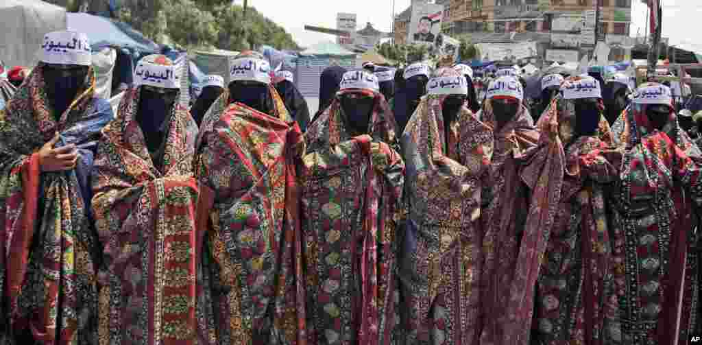 June 25, 2011: Yemeni women, wearing headbands that read in Arabic, "Housewives," participate in a demonstration in Sanaa, demanding the resignation of President Ali Abdullah Saleh. Women have been fighting to keep a voice for their rights sound