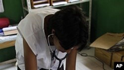 Maria Jose Caceres, a nurse for the relief organization Doctors Without Borders (MSF), listens to the chest of a child with pneumonia, at an emergency hospital run by MSF in Port-au-Prince, Haiti, May 12, 2011.