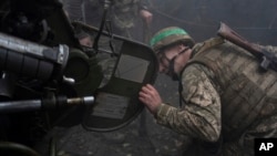 A Ukrainian serviceman of Khartia brigade checks a D-30 Howitzer aft  firing towards Russian positions successful  Kharkiv region, Ukraine, Oct. 16, 2024.