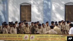 Indian policemen stand guard at Ahmedabad Central Jail, as a special court announces the verdict on a 2002 train burning case in Ahmadabad, India, February 22, 2011