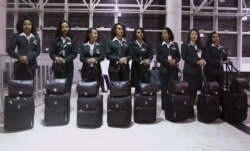 FILE - Ethiopian Airlines cabin crew members wait to get onboard the plane before takeoff at Bole international airport in the capital Addis Ababa, Nov. 18, 2015.