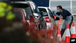Staff work at a COVID-19 testing facility at an IKEA store near Wembley stadium in London, Britain, April 29, 2020. 