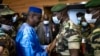 FILE - Issa Kaou N'Djim, left, greets Colonel Malick Diaw of what was then the ruling junta, prior to talks on a transitional government in Mali, Sept. 5, 2020, in Bamako. N'Djim was jailed Dec. 30, 2024, for criticizing Burkina Faso's rulers. 