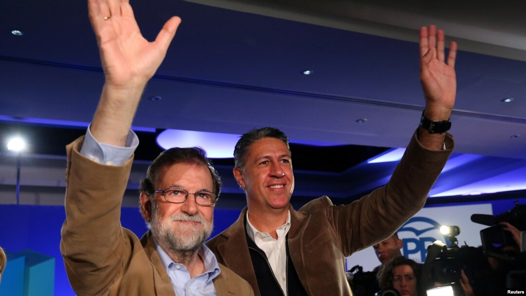 Spanish Prime Minister Mariano Rajoy and Catalan People's Party (PP) president Xavier Garcia Albiol wave as they arrive at a Catalan regional People's Party meeting in Barcelona, Nov. 12, 2017. 