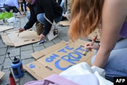 A protestor prepares a placard reading "We believe you" during a demonstration in support of Gisele Pelicot in Rennes, France, Sept. 14, 2024.