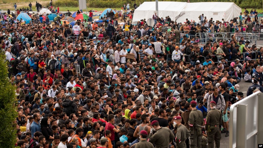 Para migran antri menunggu bis setibanya di perbatasan antara Austria dan Hungaria dekat Heiligenkreuz, 180 kilometer selatan Wina, Austria (19/9).