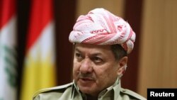 FILE - Iraqi Kurdistan President Masoud Barzani says the killers of the Kurdish fighters "will see how the hand of the heroic peshmerga will reach them."
