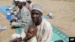 FILE - During an interview with the Associated Press at Furore camp in Yola, Nigeria, Dec. 8, 2015, Mariamu Abubakar, a Cameroonian farmer, described that soldiers killed about 150 people in his village near Nigeria's Banki border post, stole their livestock and set their huts ablaze on Nov. 30.