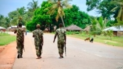FILE - Soldiers from the Mozambican army patrol the streets after security in the area was increased, following a two-day attack from suspected Islamists in October 2017, in Mocimboa da Praia, Mozambique, March 7, 2018.