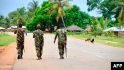 FILE - In this file photo taken March 7, 2018, soldiers from the Mozambican army patrol the streets after security in the area was increased, in Mocimboa da Praia, Mozambique.